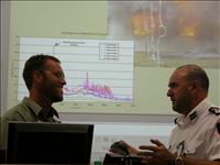 Justin Leonard, left, discusses his research with Michael Ross of the ACT Rural Fire Service.