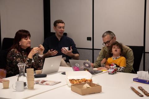 People gathered around a table talking